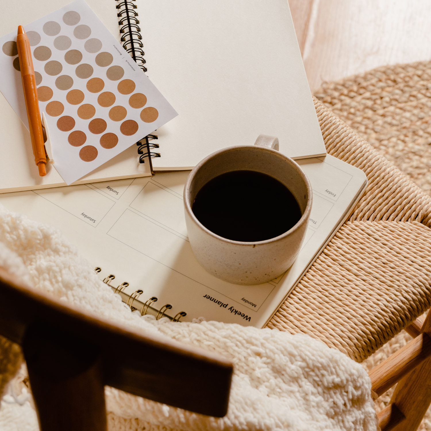 Your Legal Requirements as an affiliate or influencer - cup of coffee sitting on a chair, with a blank notebook