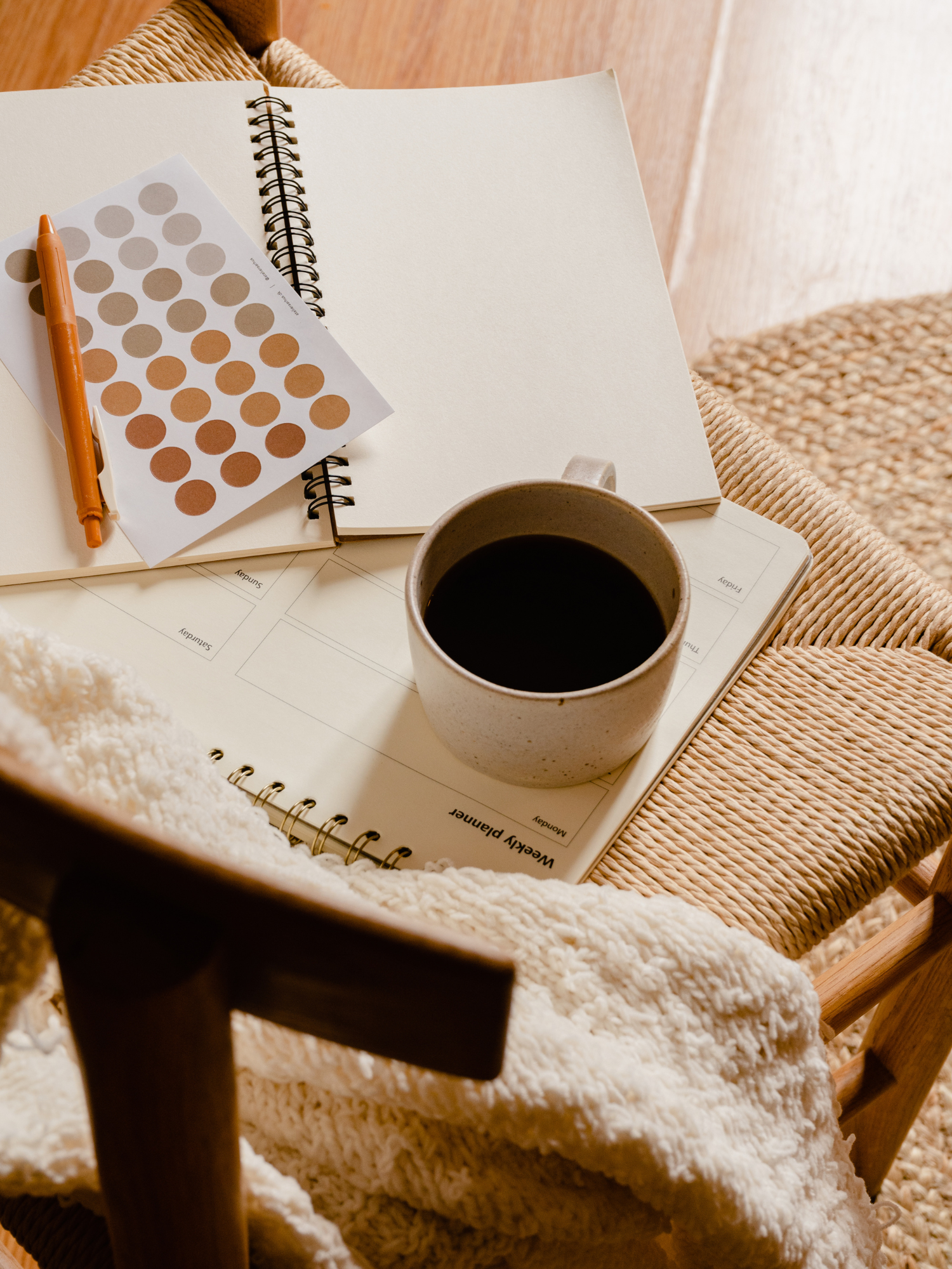 Your Legal Requirements as an affiliate or influencer - cup of coffee sitting on a chair, with a blank notebook