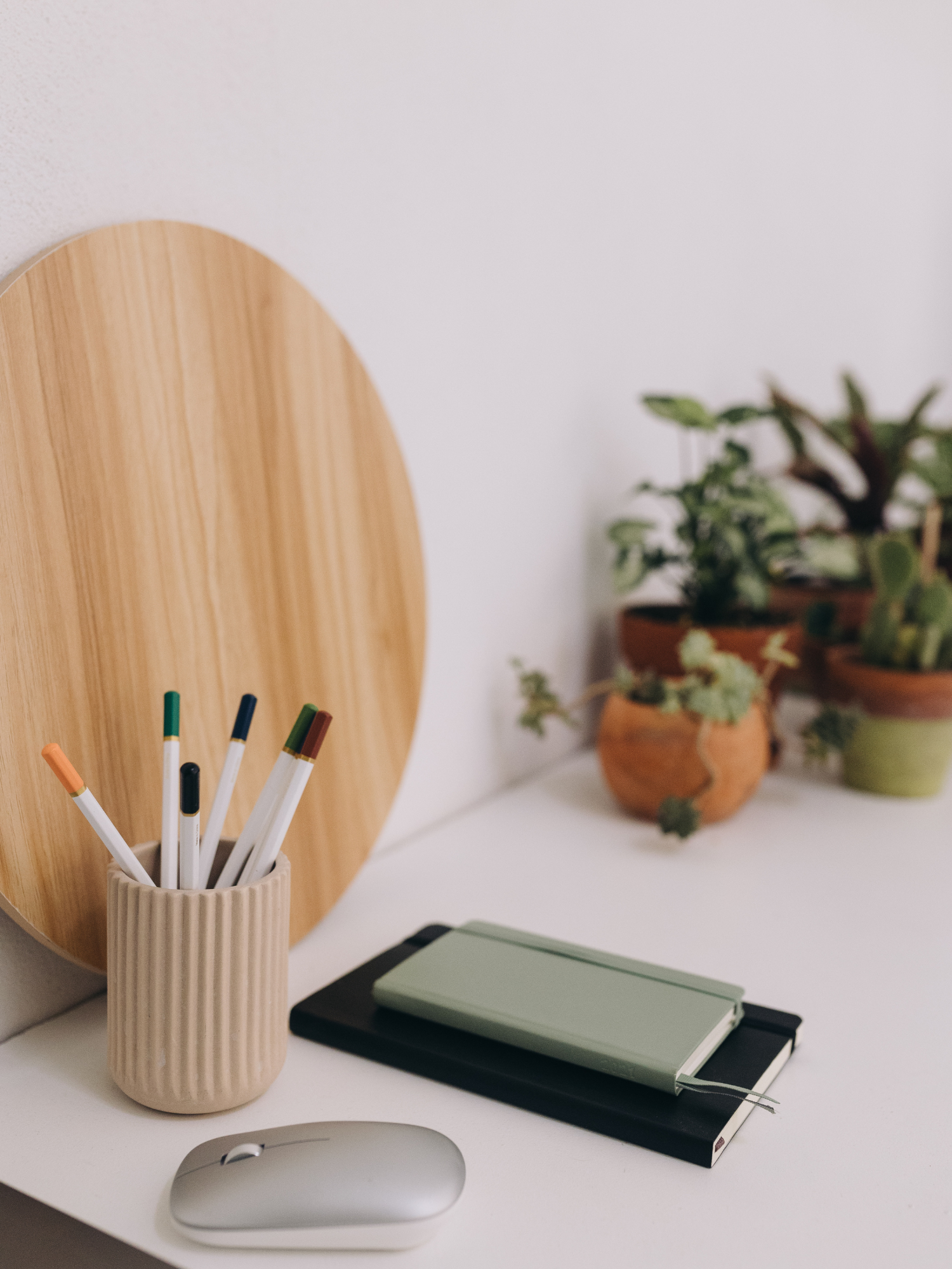 The Right Way to make changes to a contract - Image of green notebook with a mug of pens against a white backdrop